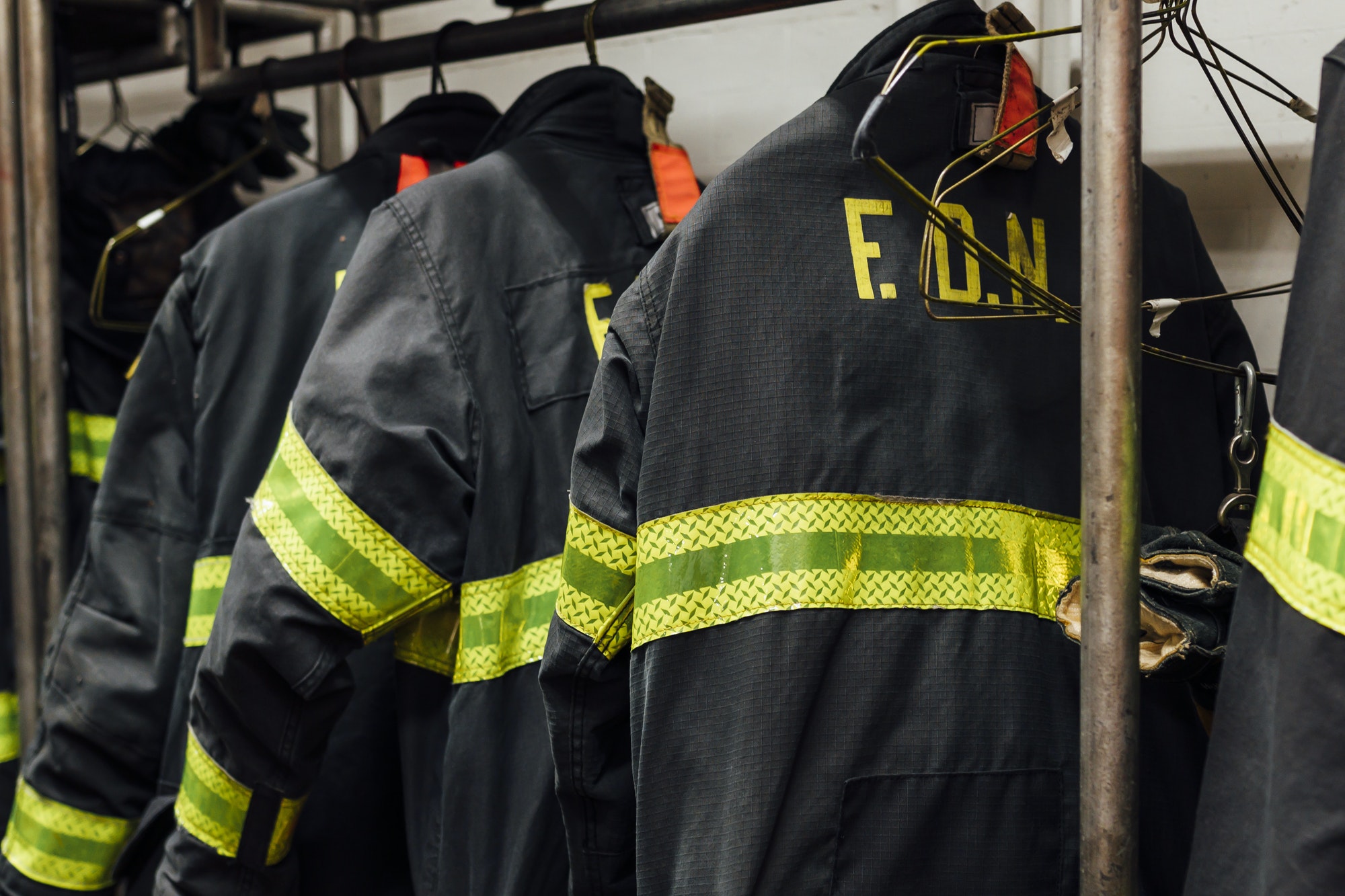 Firefighters' uniforms inside a firehouse